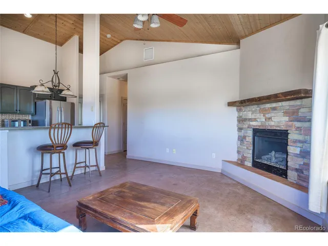 a living room with furniture a fireplace and a table