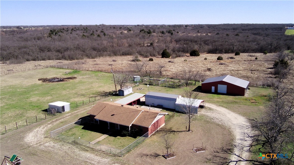 a view of yard with mountain and trees in the background