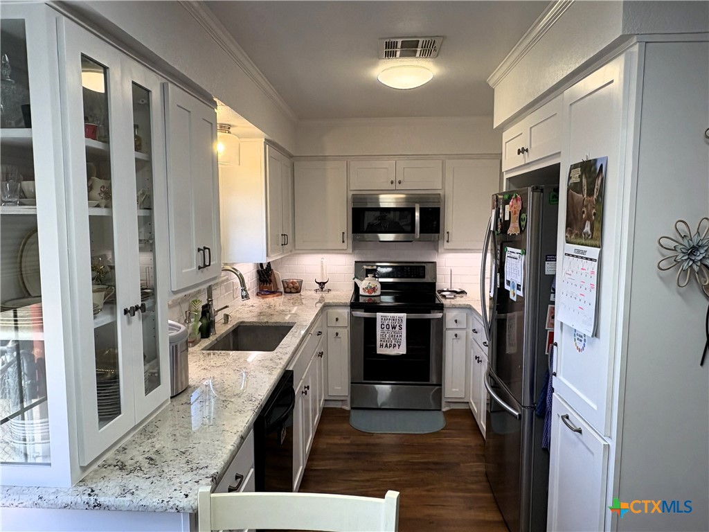 936 County Road 109 Riesel, TX 76682 - Photo 6 of 22 a kitchen with stainless steel appliances a refrigerator a stove a sink and a refrigerator
