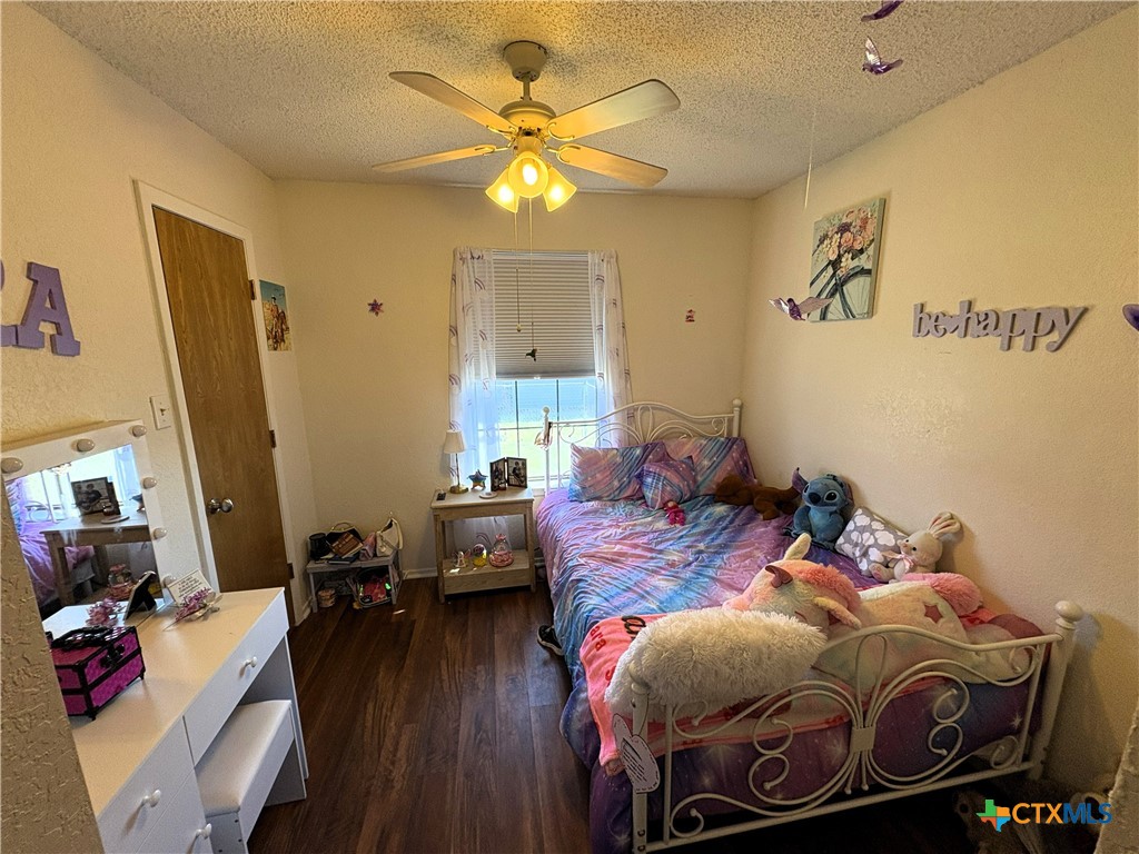 936 County Road 109 Riesel, TX 76682 - Photo 10 of 22 a bed room with a bed and a chandelier