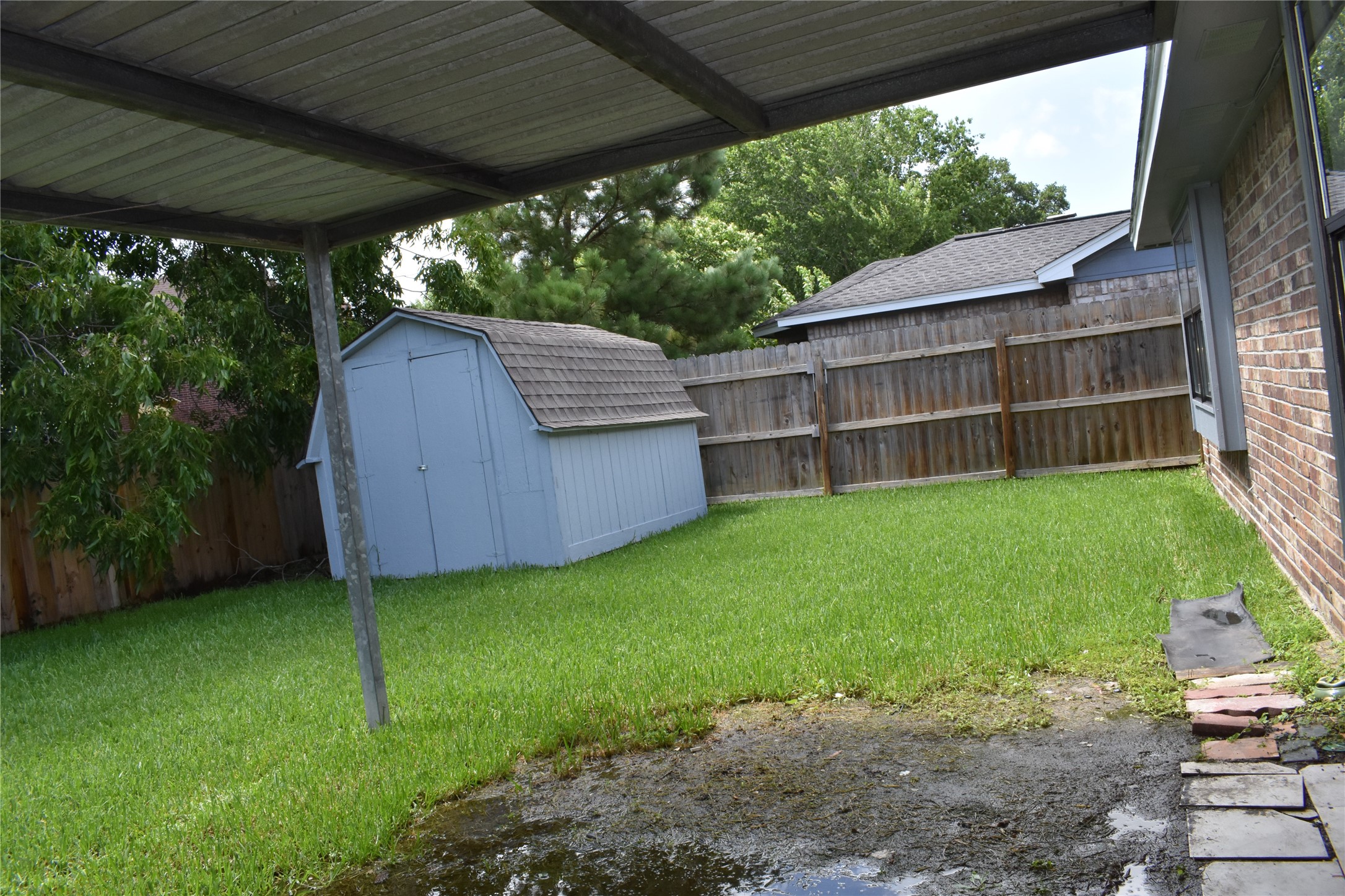 1347 Somercotes Lane Channelview, TX 77530 - Photo 24 of 30 a view of backyard with a barn and large trees