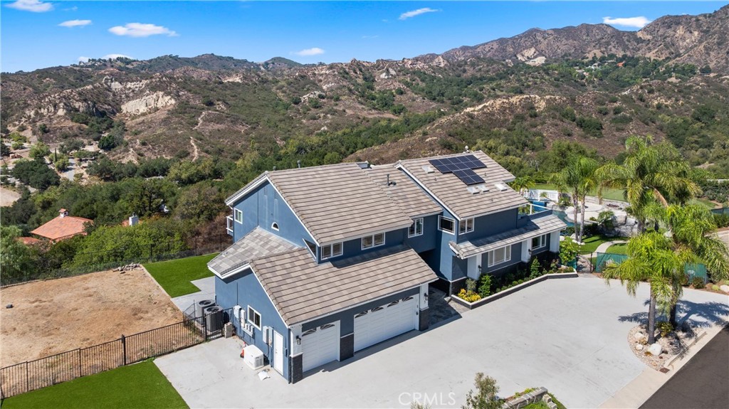 3 Windy Ridge Road Trabuco Canyon, CA 92679 - Photo 1 of 59 an aerial view of a house with a yard and mountain view in back
