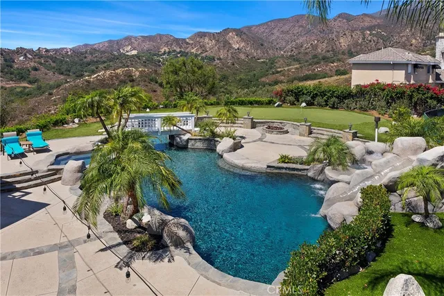 a view of swimming pool with outdoor seating and plants