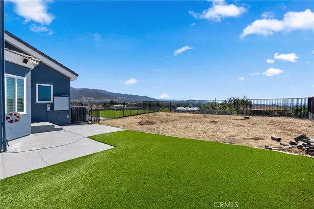 a kitchen with stainless steel appliances granite countertop a refrigerator a sink dishwasher a stove and white countertops with wooden floor