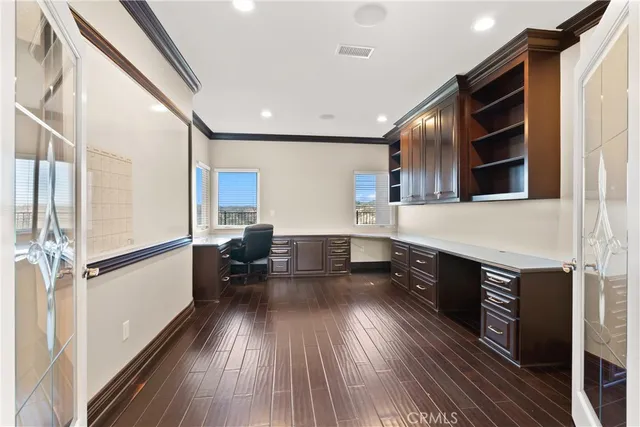 a living room with furniture wooden floor and a large window