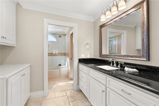 a kitchen with stainless steel appliances granite countertop a sink and a refrigerator