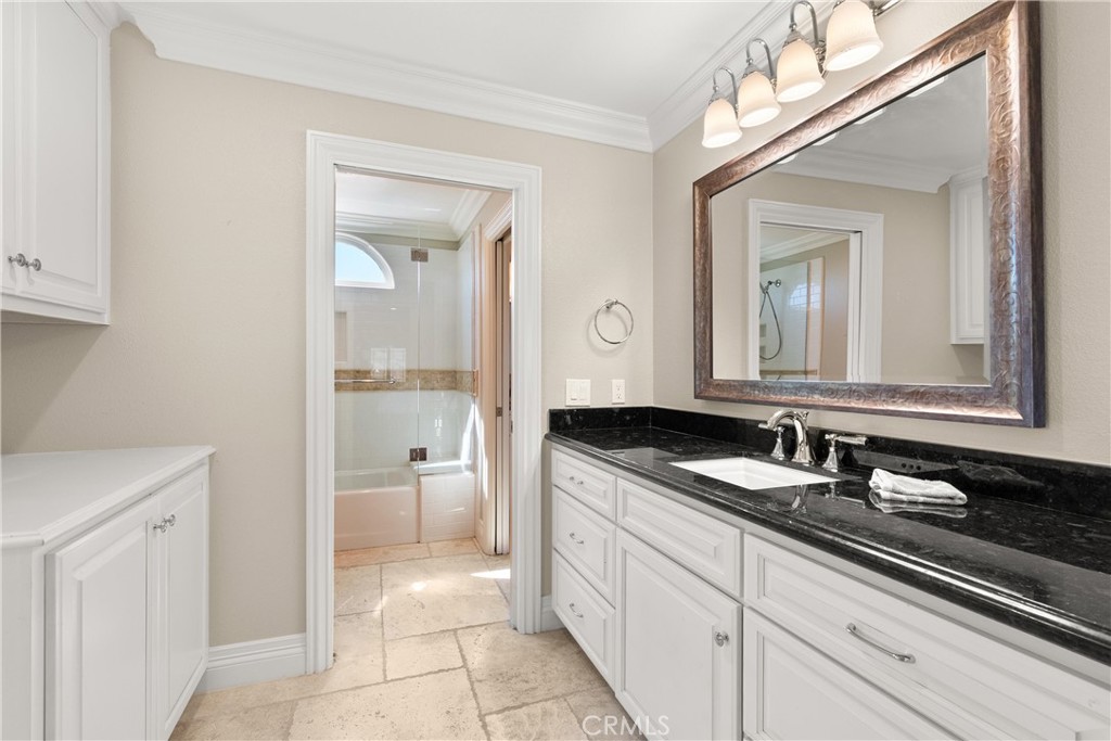 3 Windy Ridge Road Trabuco Canyon, CA 92679 - Photo 38 of 59 a en suite bathroom with a granite countertop sink and a mirror