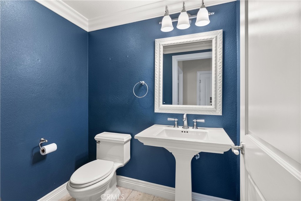 3 Windy Ridge Road Trabuco Canyon, CA 92679 - Photo 43 of 59 a bathroom with a toilet a sink and mirror