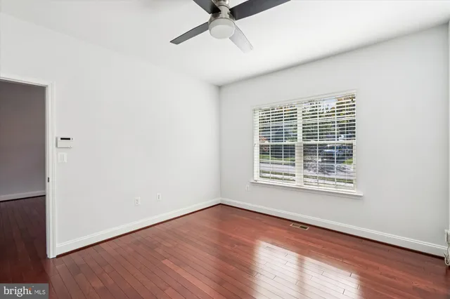 a bathroom with a granite countertop sink a toilet and a mirror