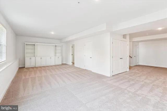 an empty room with white wall and white walls