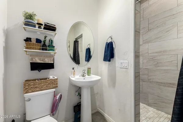 a bedroom with a bed and a chandelier fan