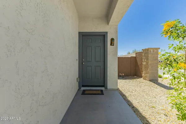 a view of a hallway to closet and a living room