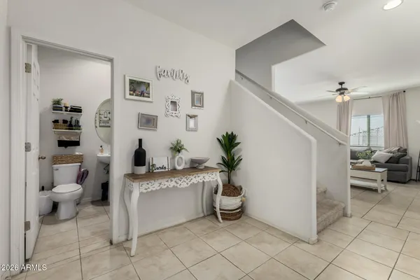 a living room with furniture and a view of kitchen