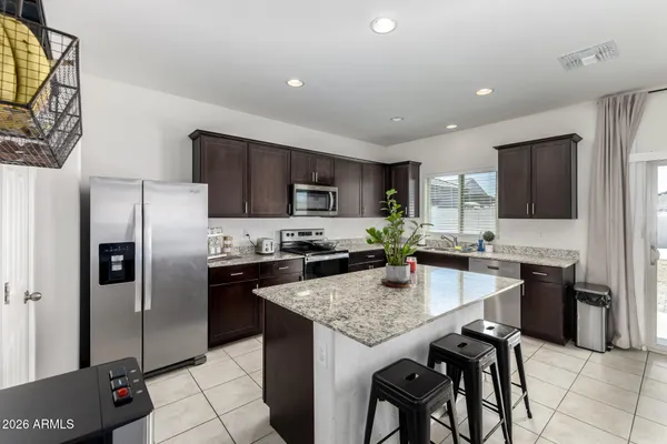 a kitchen with granite countertop stainless steel appliances and wooden cabinets