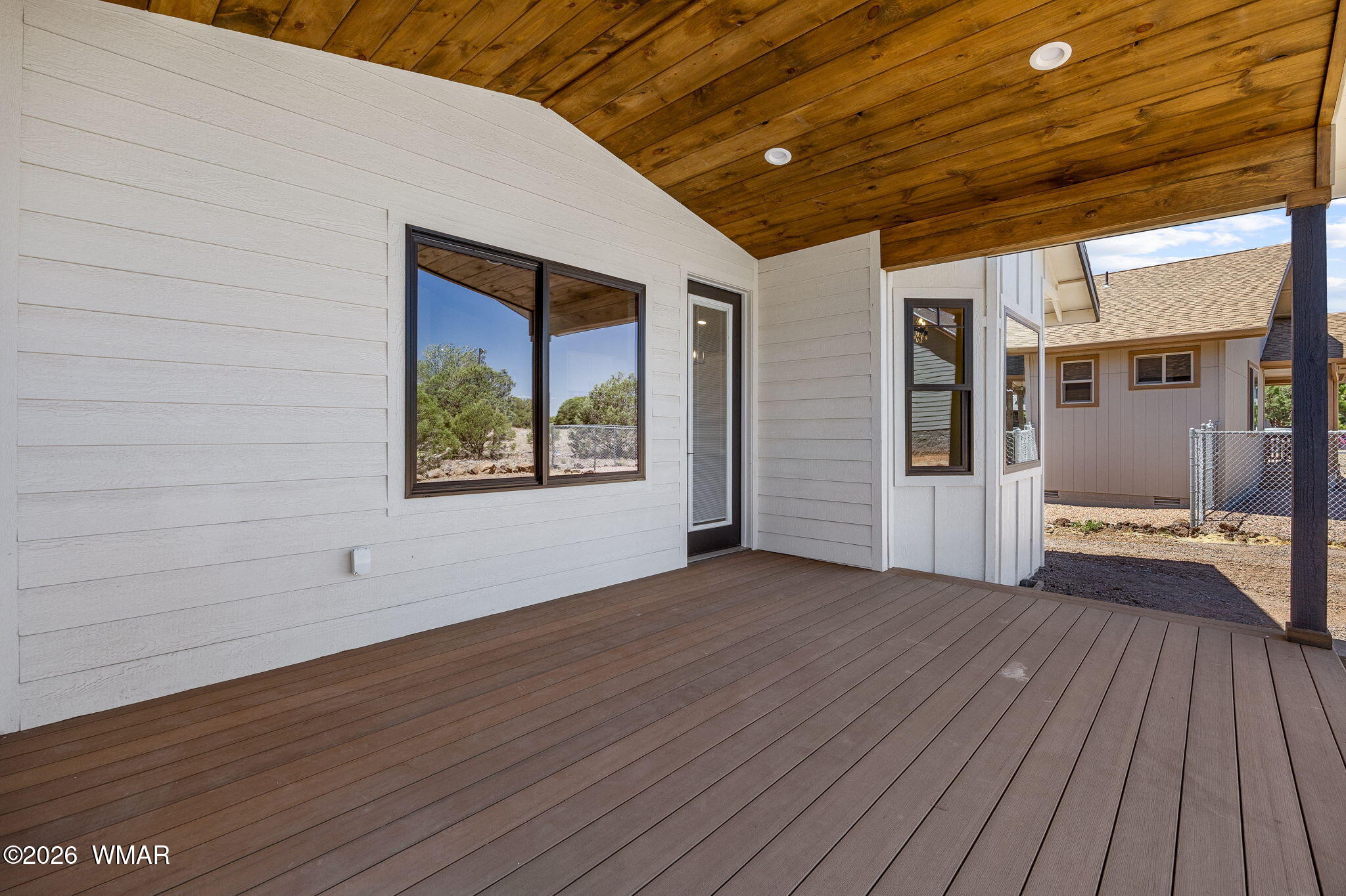 561 South Rock Ridge Drive Show Low, AZ 85901 - Photo 20 of 28 a view of an empty room with wooden floor and a window
