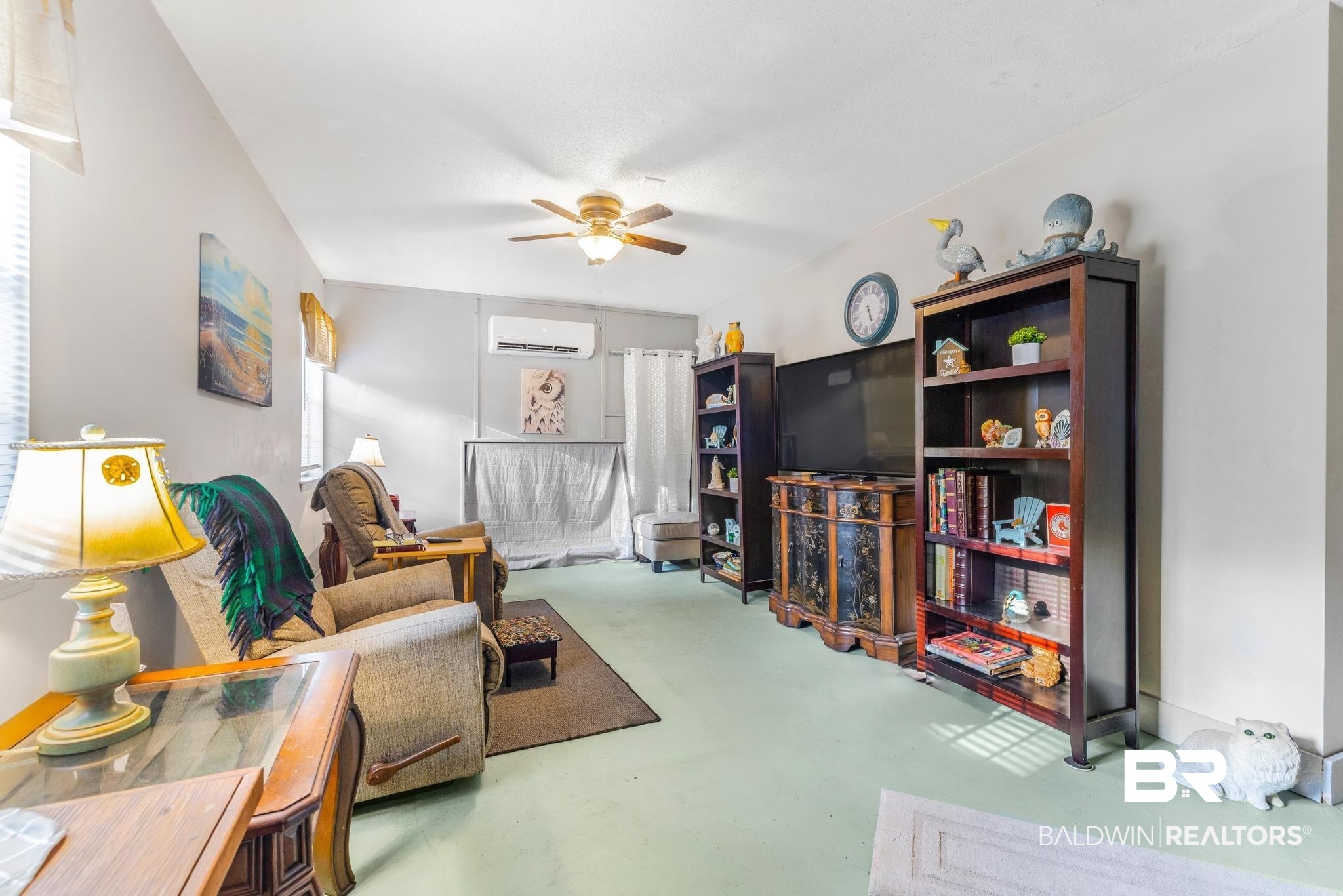 2573 E Road Mobile, AL 36693 - Photo 33 of 45 Living area featuring a ceiling fan, finished concrete flooring, and a wall unit AC