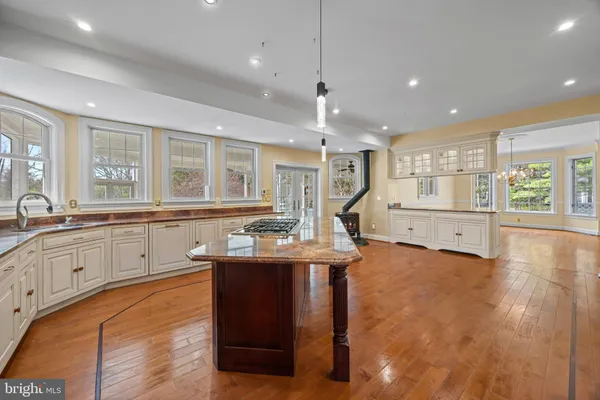 a large white kitchen with a large window