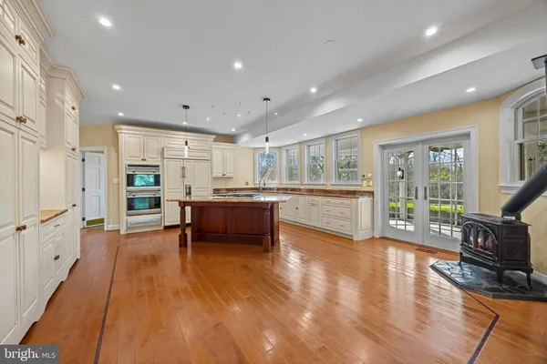 a living room with stainless steel appliances furniture and a kitchen view