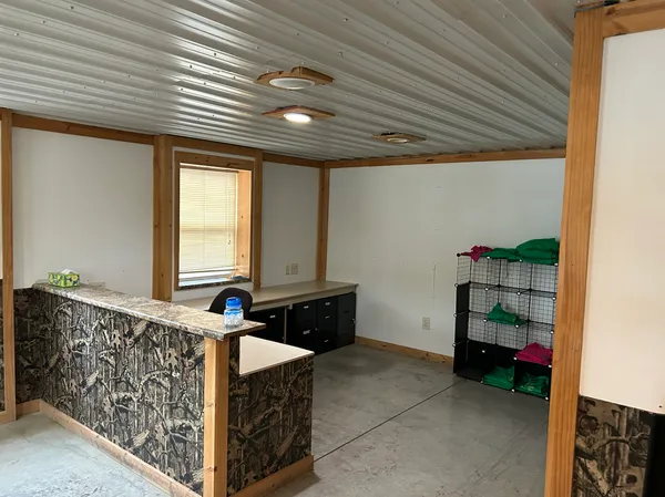 a room with pool table and windows