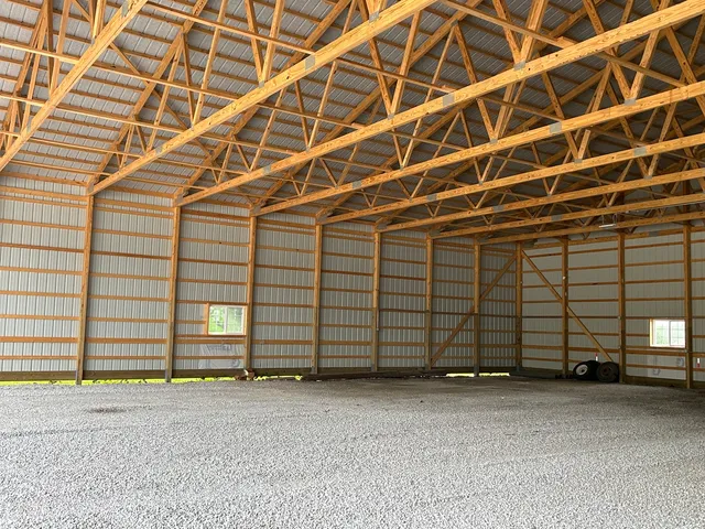 a view of a room with wooden walls and window