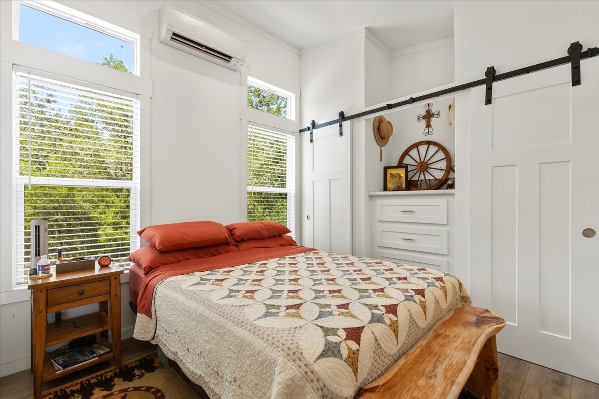 1705 Makinson Road West Point, TX 78963 - Photo 7 of 40 A restful primary bedroom retreat with wide windows and barn doors.