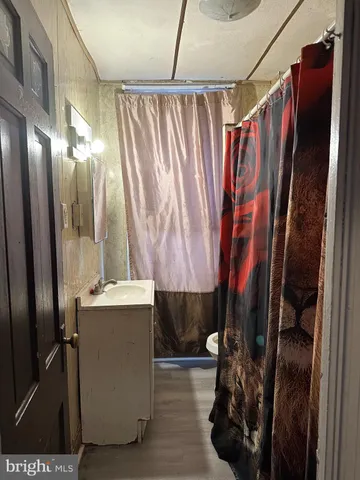 a bathroom with a shower and a sink