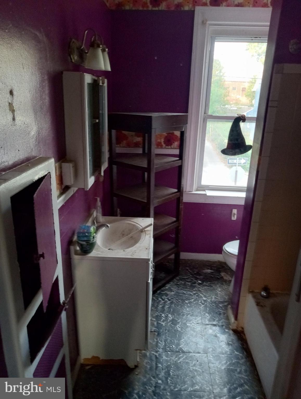 4417 Old York Road Baltimore, MD 21212 - Photo 4 of 6 a room with furniture a flat screen tv and a fireplace