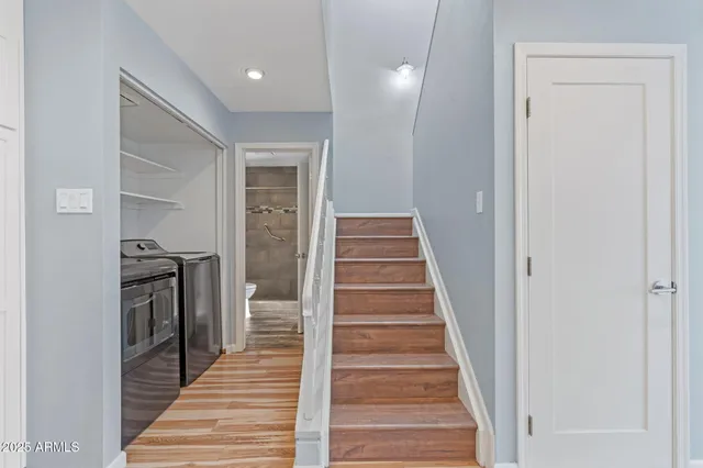 a view of a hallway with wooden floor and entryway