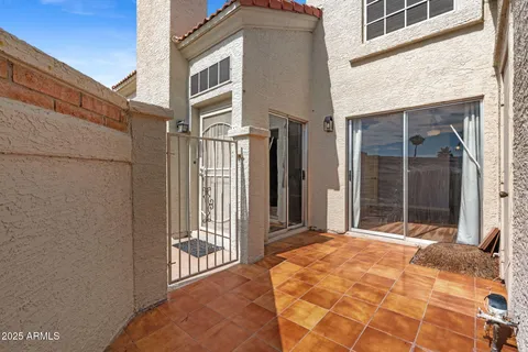 a view of a brick house with large windows