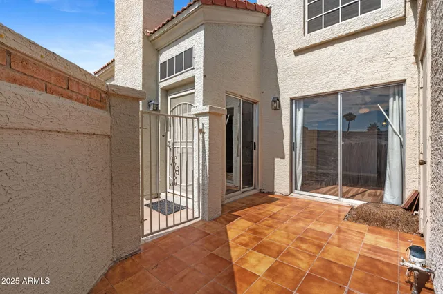 a view of a brick house with large windows