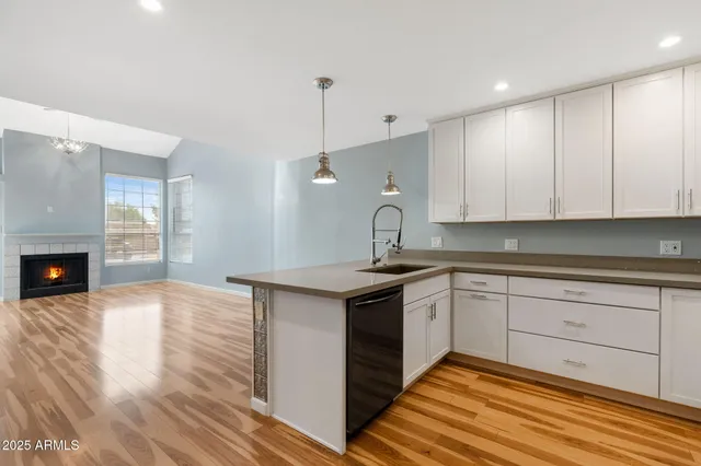 a kitchen with a sink cabinets and wooden floor