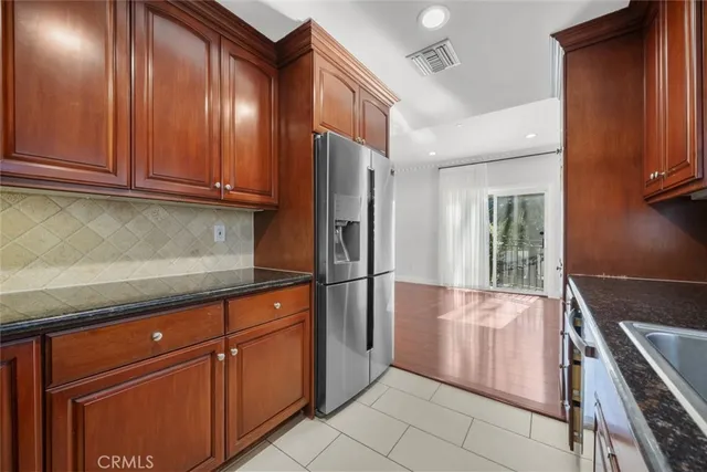 a kitchen with granite countertop stainless steel appliances and wooden cabinets