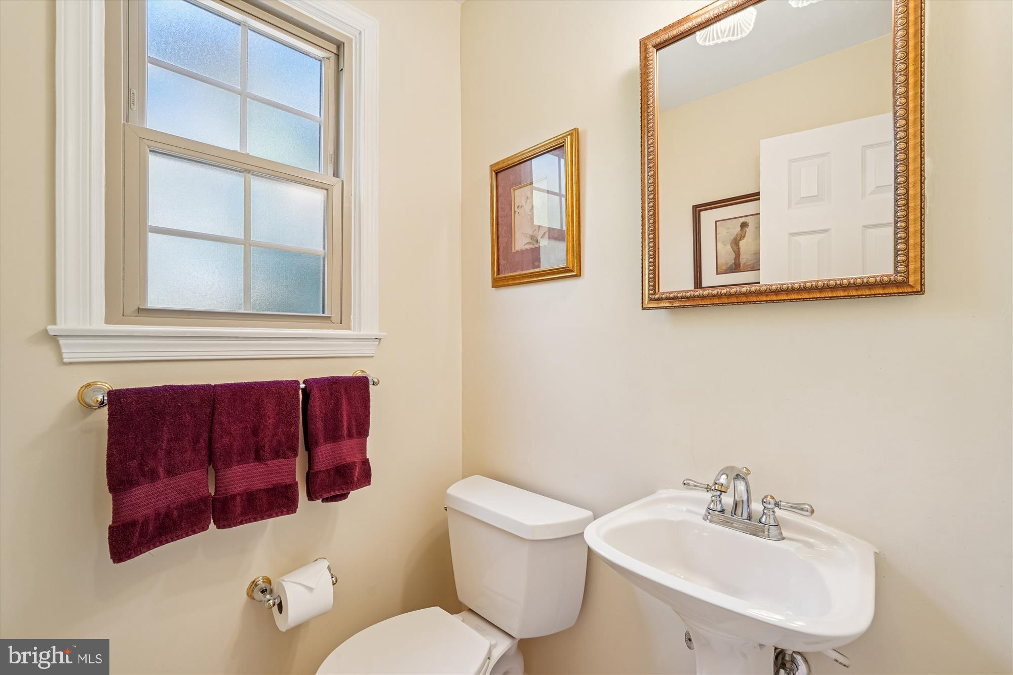 15417 Aylesbury Street Silver Spring, MD 20905 - Photo 22 of 65 a bathroom with a toilet a sink and a mirror