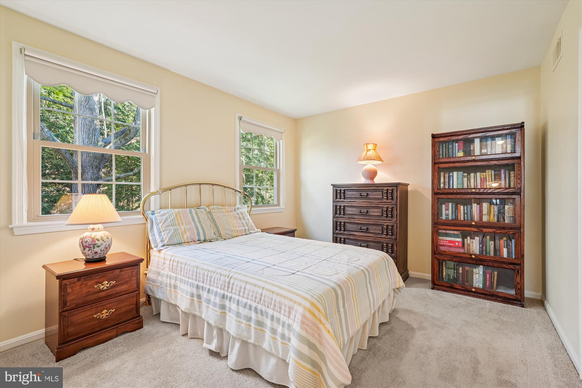 15417 Aylesbury Street Silver Spring, MD 20905 - Photo 23 of 65 a bedroom with a bed a dresser and a large window