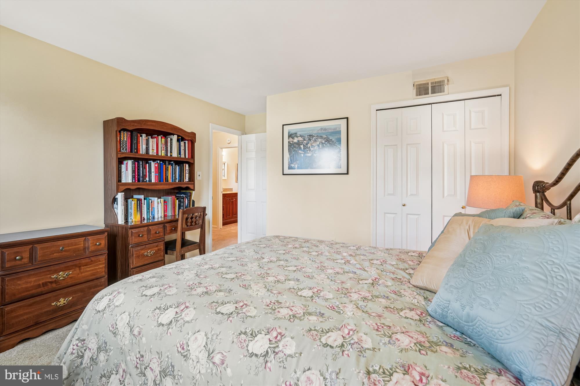 15417 Aylesbury Street Silver Spring, MD 20905 - Photo 27 of 65 a bedroom with a bed and a book shelf