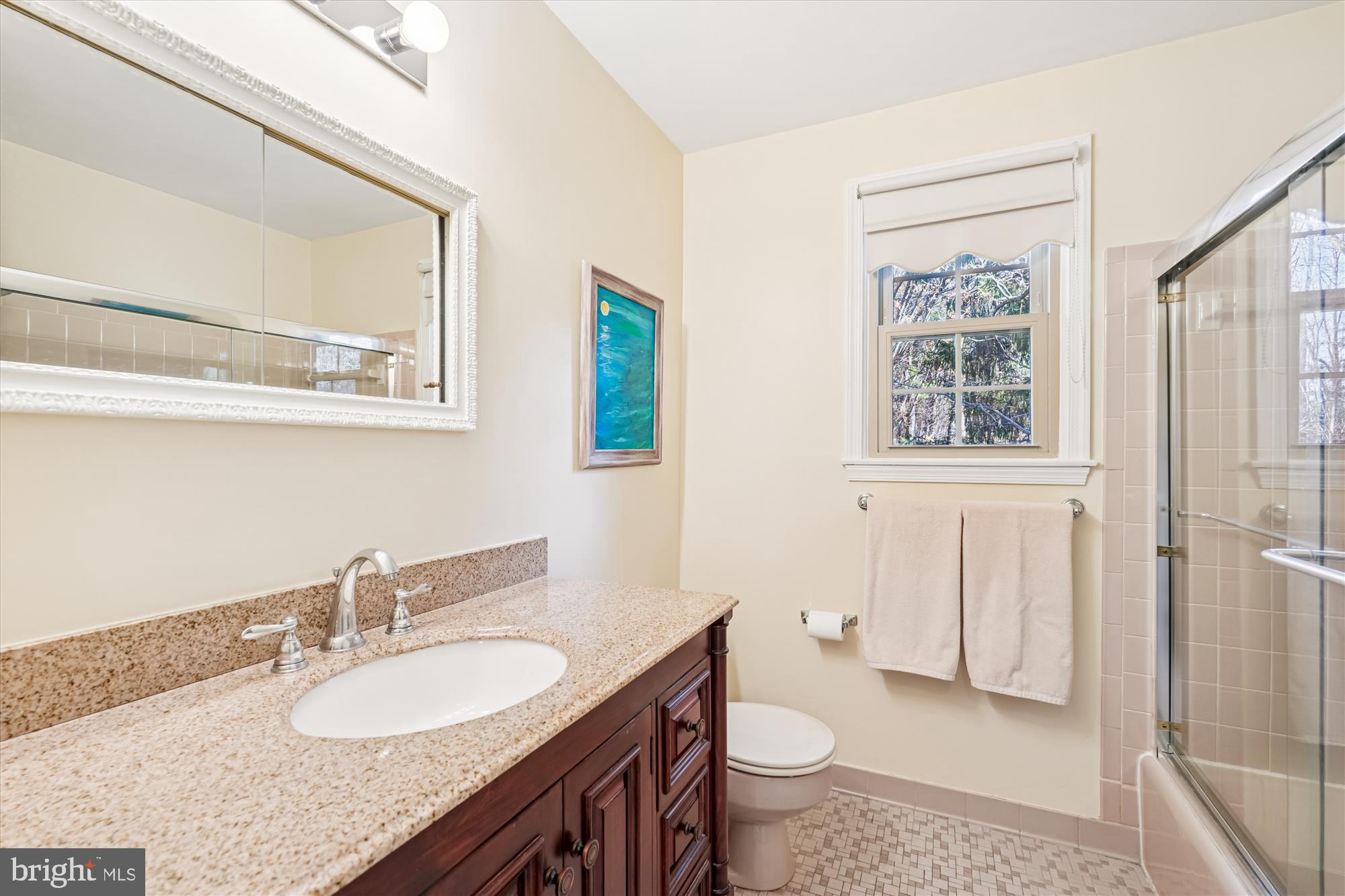 15417 Aylesbury Street Silver Spring, MD 20905 - Photo 30 of 65 a bathroom with a granite countertop sink and a mirror