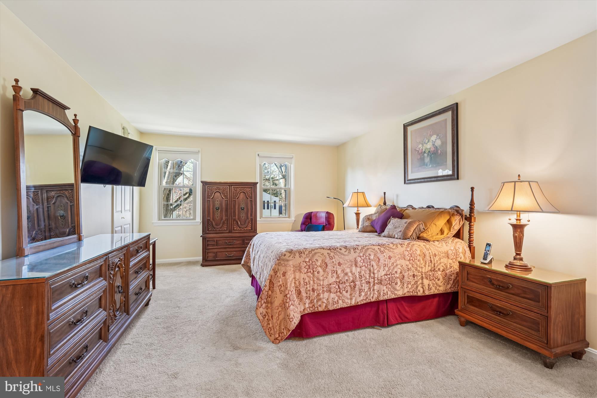 15417 Aylesbury Street Silver Spring, MD 20905 - Photo 32 of 65 a spacious bedroom with a bed and a flat screen tv