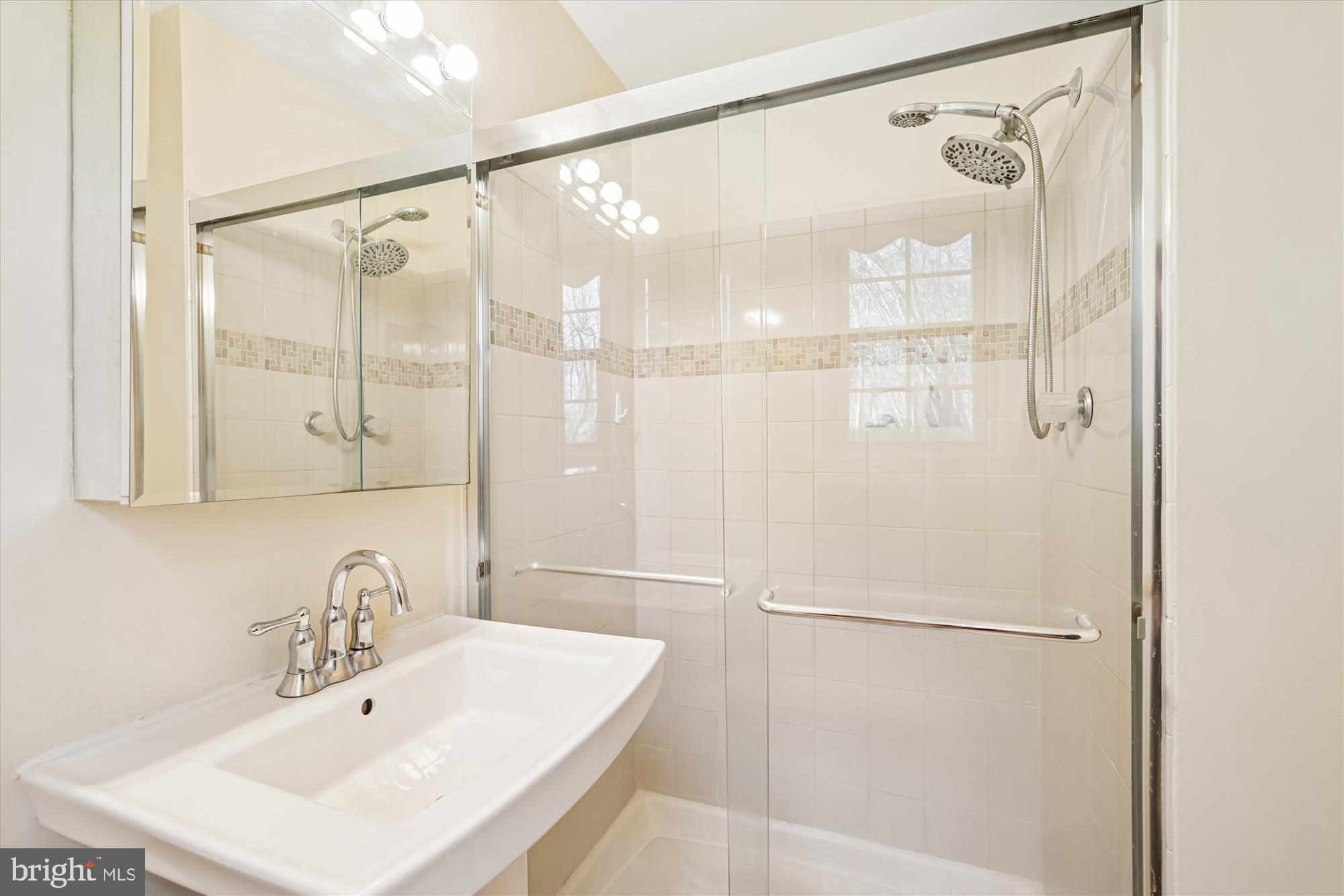 15417 Aylesbury Street Silver Spring, MD 20905 - Photo 38 of 65 a bathroom with a shower and a sink