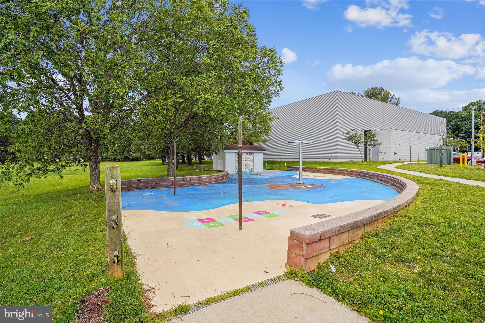 15417 Aylesbury Street Silver Spring, MD 20905 - Photo 51 of 65 a swimming pool with some trees in the background