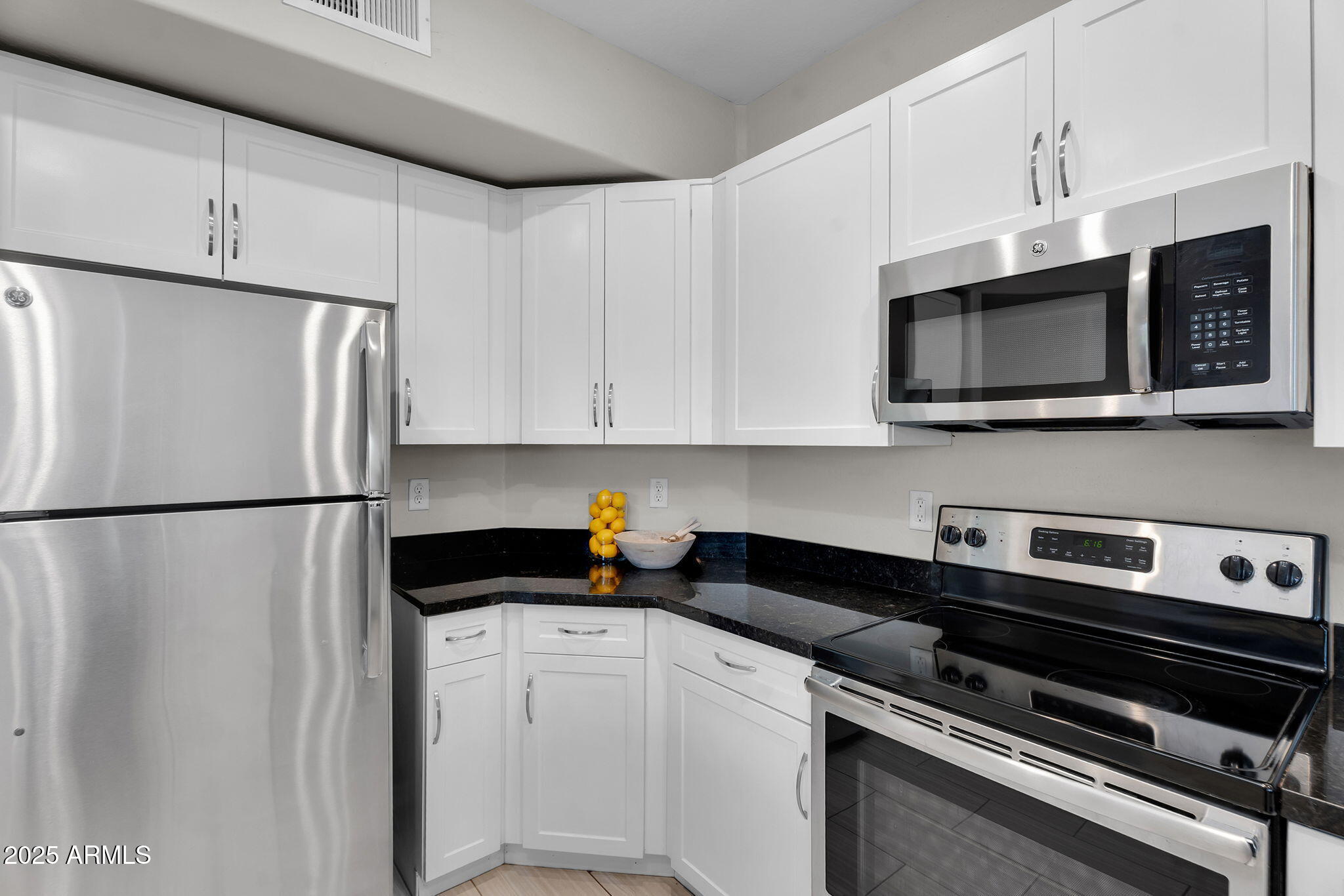 3330 South Gilbert Road, Unit 1075 Chandler, AZ 85286 - Photo 14 of 70 a kitchen with stainless steel appliances a refrigerator a stove a microwave and cabinets