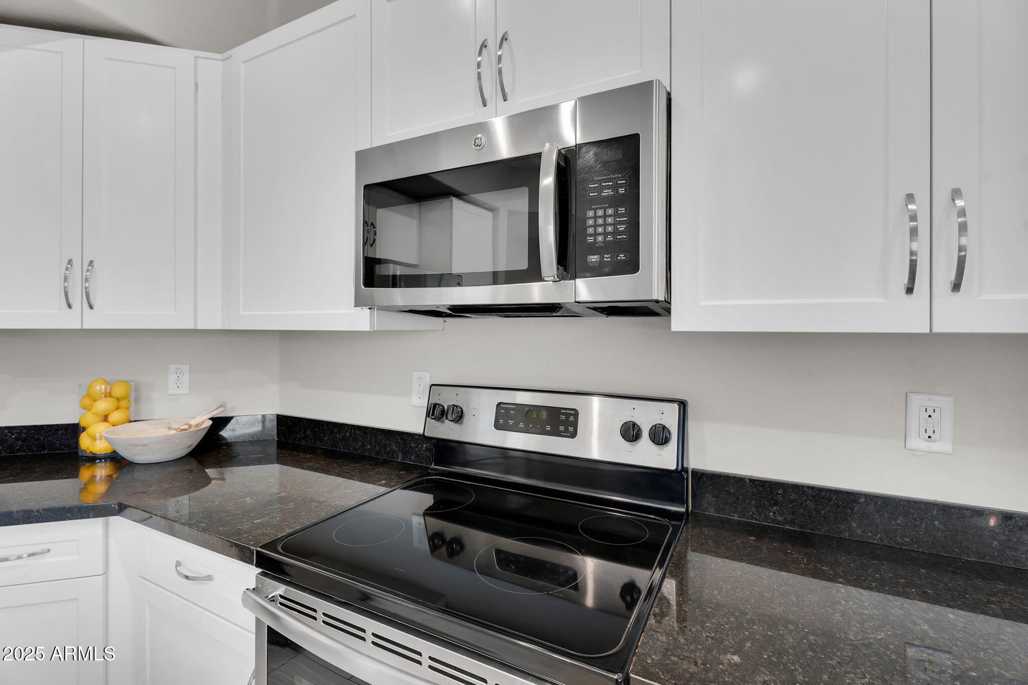 3330 South Gilbert Road, Unit 1075 Chandler, AZ 85286 - Photo 15 of 70 a kitchen with stainless steel appliances granite countertop a stove and a microwave