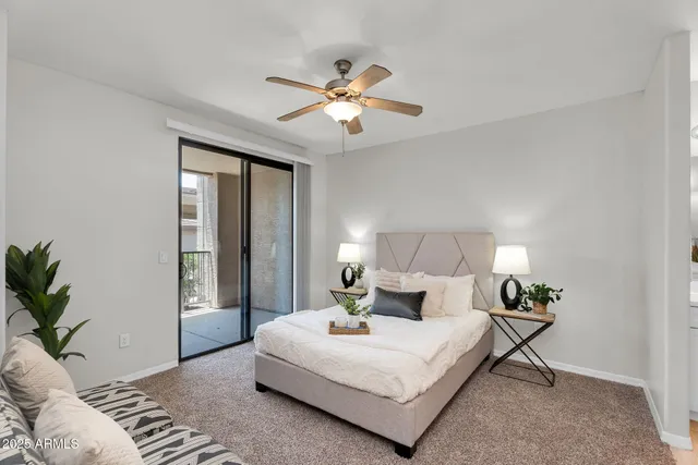 a view of a hallway with a livingroom and bedroom with furniture