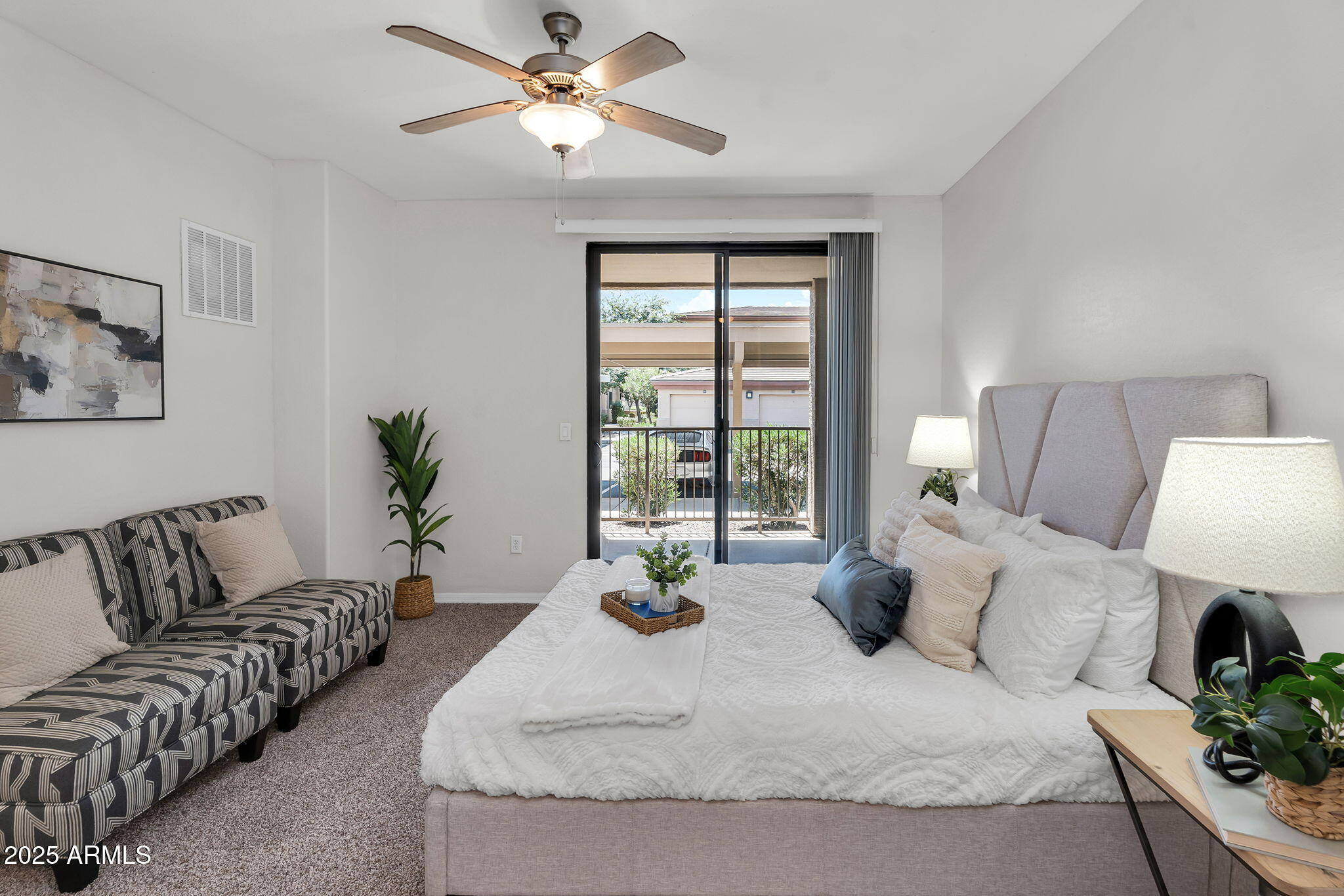 3330 South Gilbert Road, Unit 1075 Chandler, AZ 85286 - Photo 20 of 70 a bedroom with a large bed and a couch
