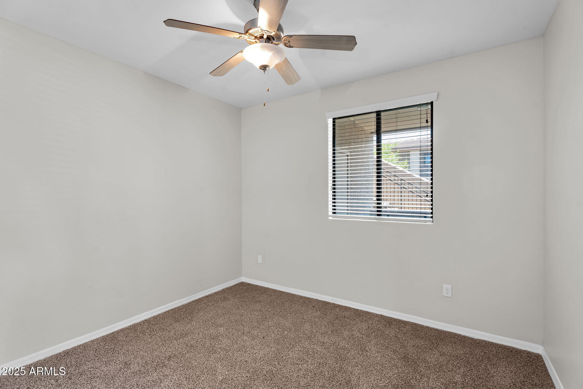 3330 South Gilbert Road, Unit 1075 Chandler, AZ 85286 - Photo 35 of 70 an empty room with a window and a fan