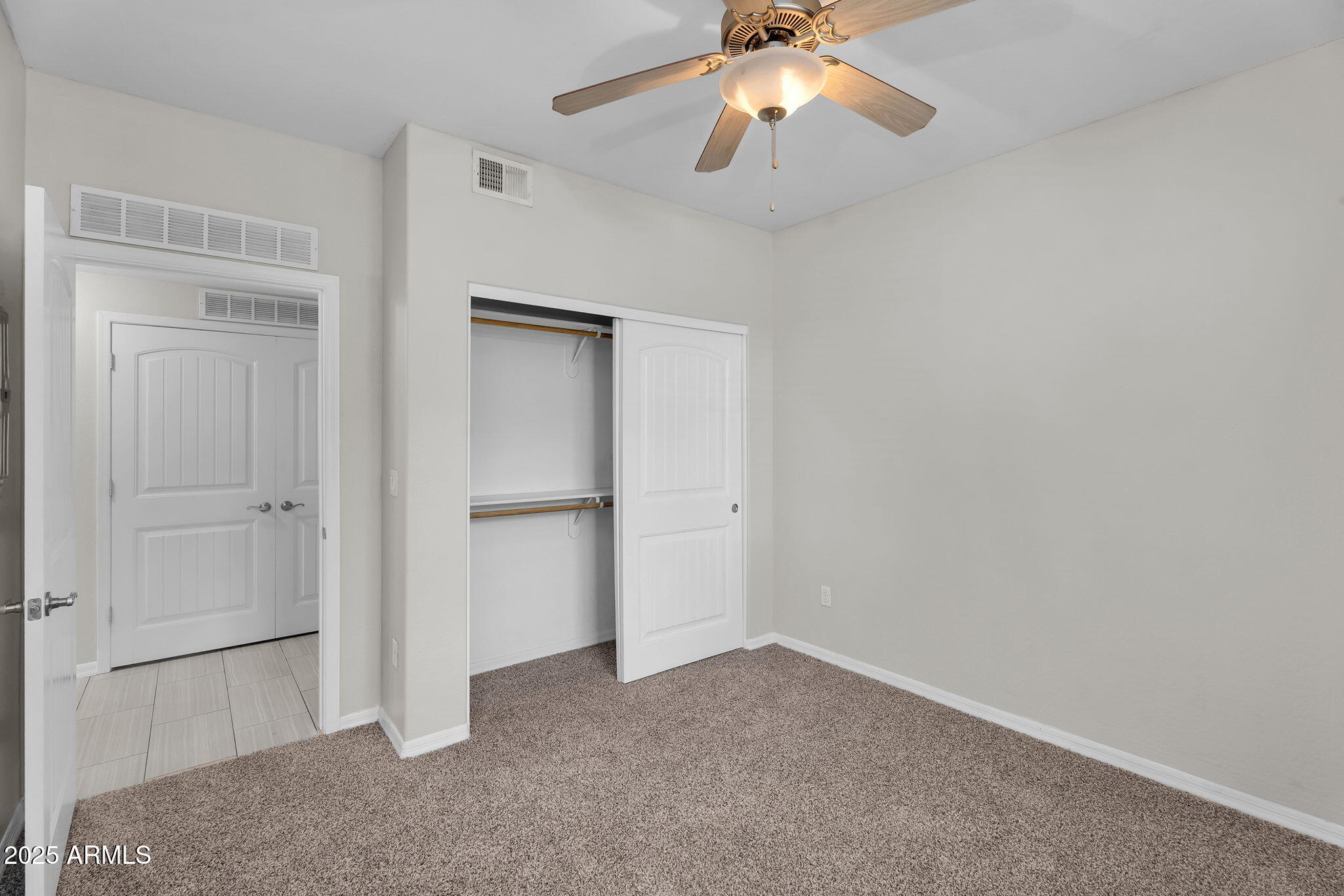 3330 South Gilbert Road, Unit 1075 Chandler, AZ 85286 - Photo 36 of 70 an empty room with closet and a chandelier fan