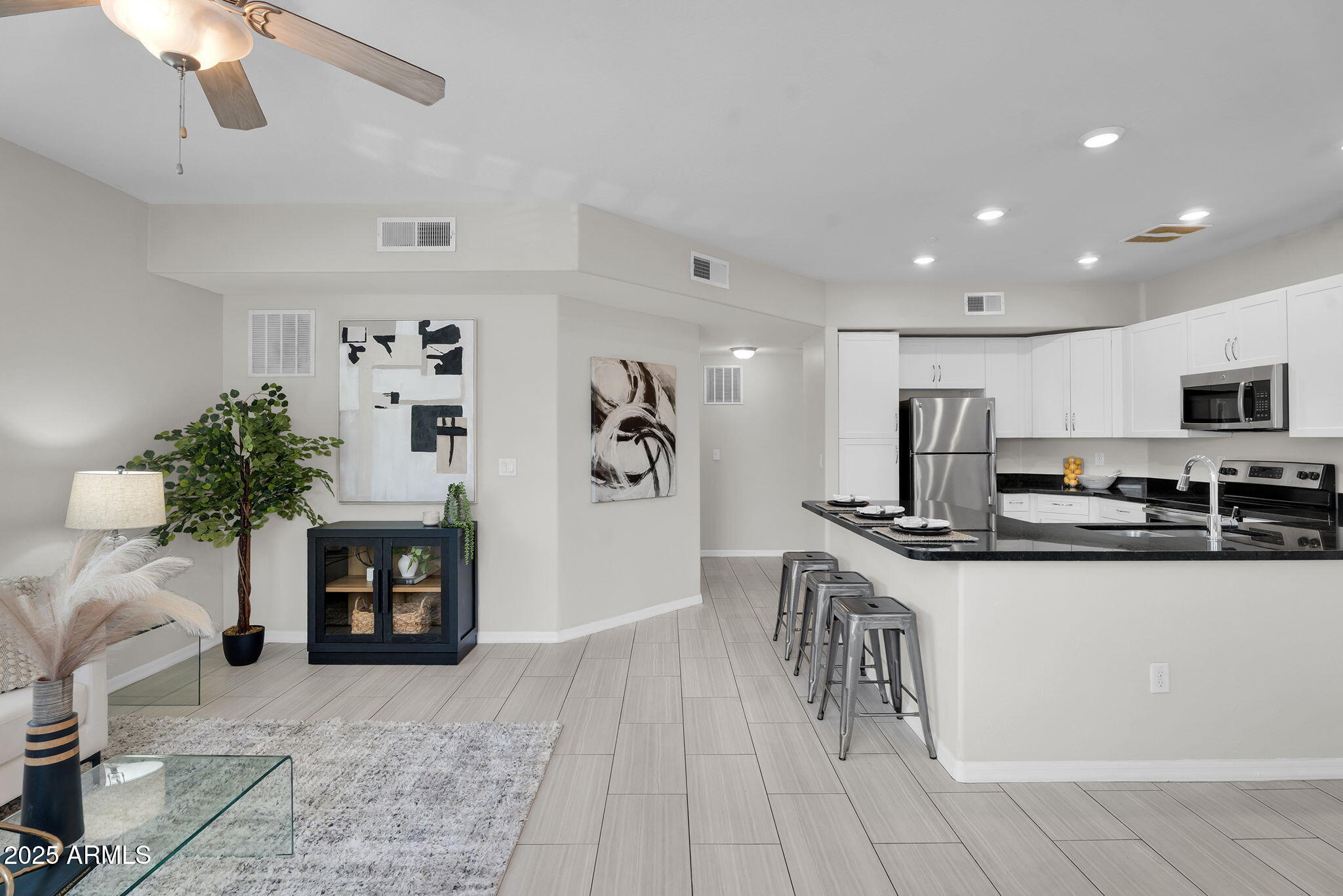 3330 South Gilbert Road, Unit 1075 Chandler, AZ 85286 - Photo 9 of 70 a kitchen with stainless steel appliances granite countertop a refrigerator and a stove top oven