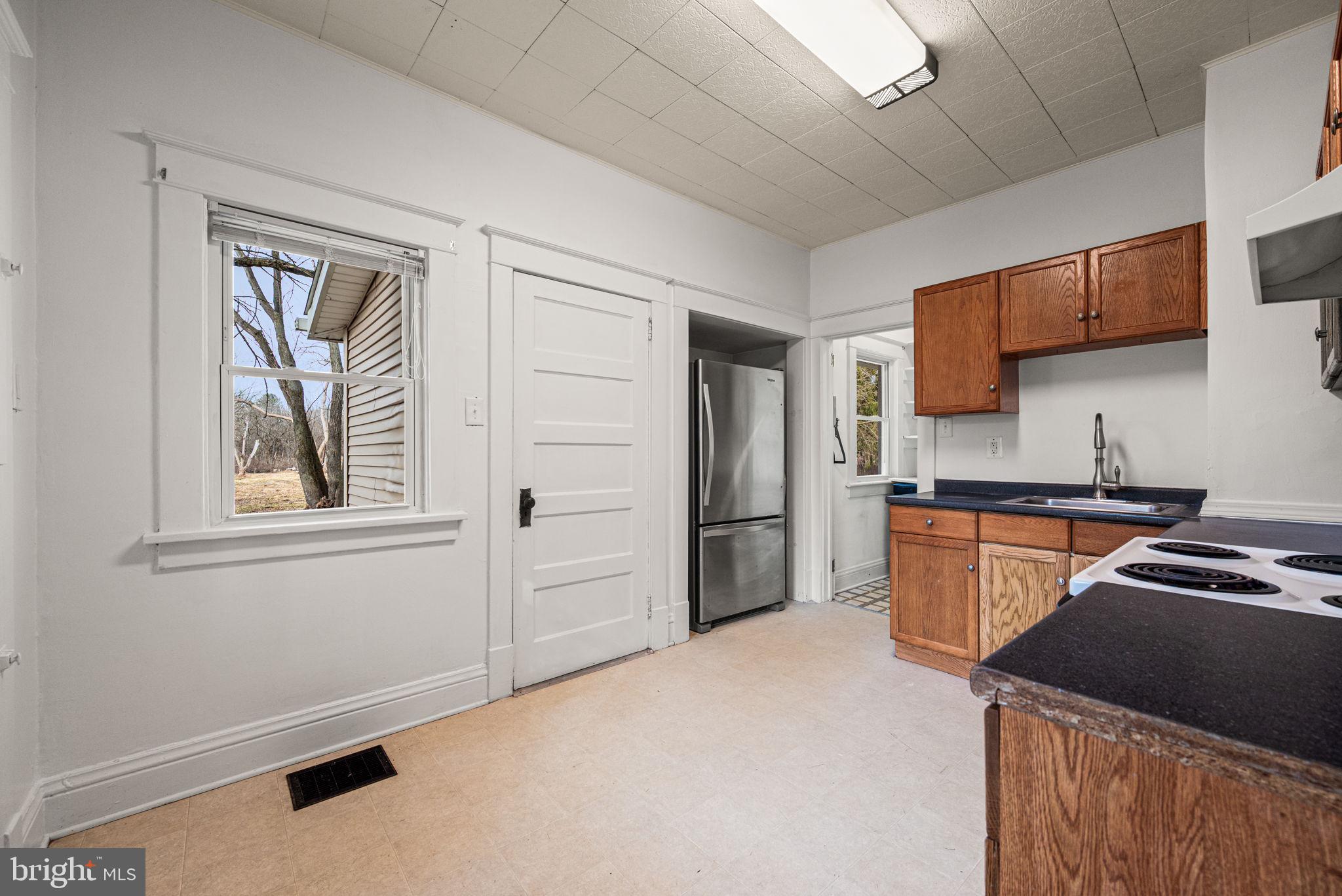 1026 Hares Hill Road Phoenixville, PA 19460 - Photo 11 of 27 a kitchen with granite countertop cabinets and refrigerator