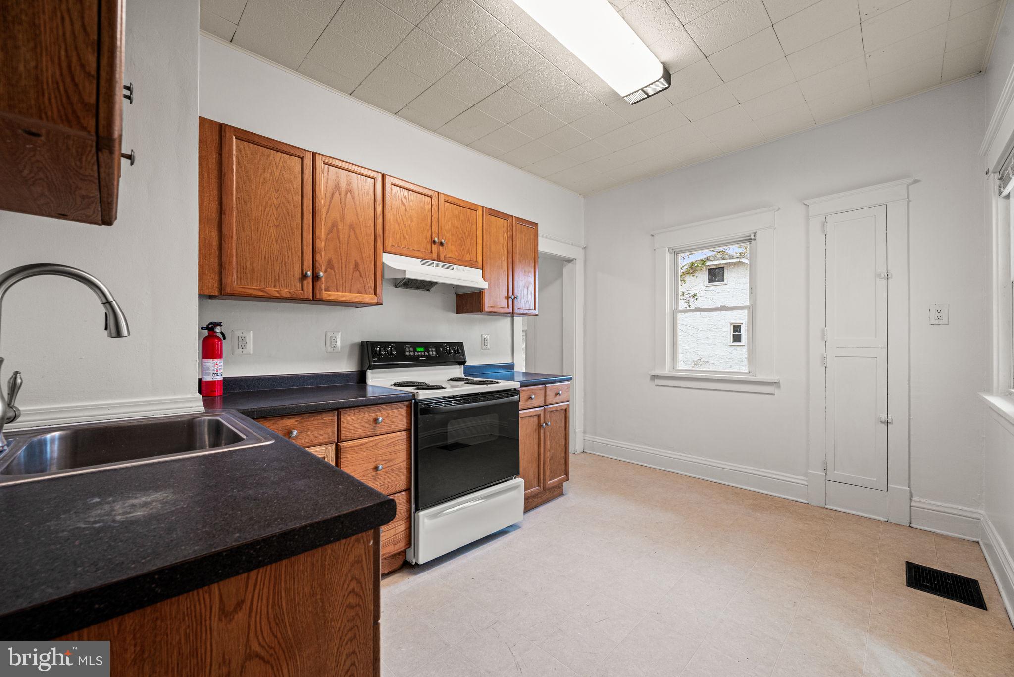 1026 Hares Hill Road Phoenixville, PA 19460 - Photo 12 of 27 a kitchen with stainless steel appliances granite countertop a stove a sink and a microwave
