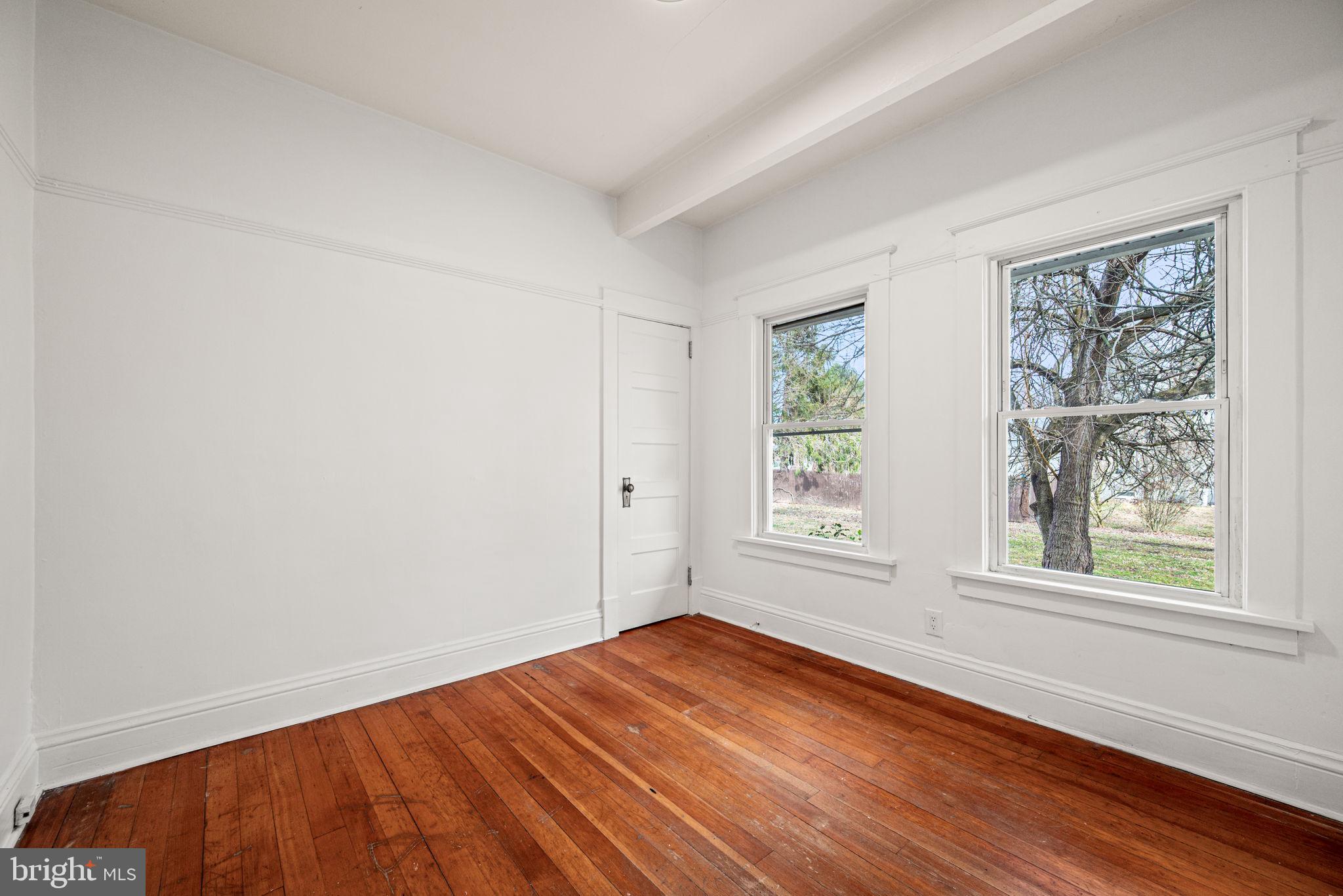 1026 Hares Hill Road Phoenixville, PA 19460 - Photo 14 of 27 an empty room with wooden floor and windows
