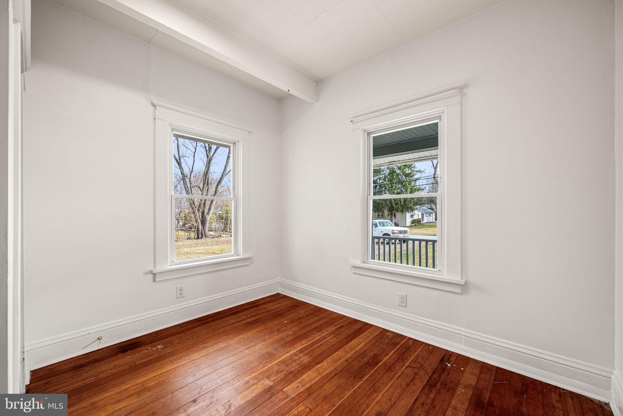 1026 Hares Hill Road Phoenixville, PA 19460 - Photo 18 of 27 an empty room with wooden floor and windows